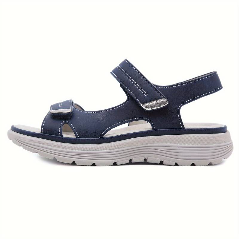 Navy blue orthopedic sandal with adjustable Velcro straps, cushioned sole, and ergonomic design for comfort and support. Ideal for walking.