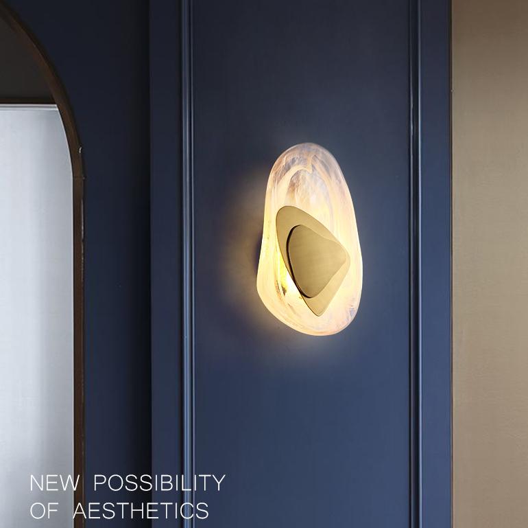 Modern wall sconce with abstract design on navy blue wall, featuring warm ambient lighting. Contemporary home decor, stylish lighting fixture.