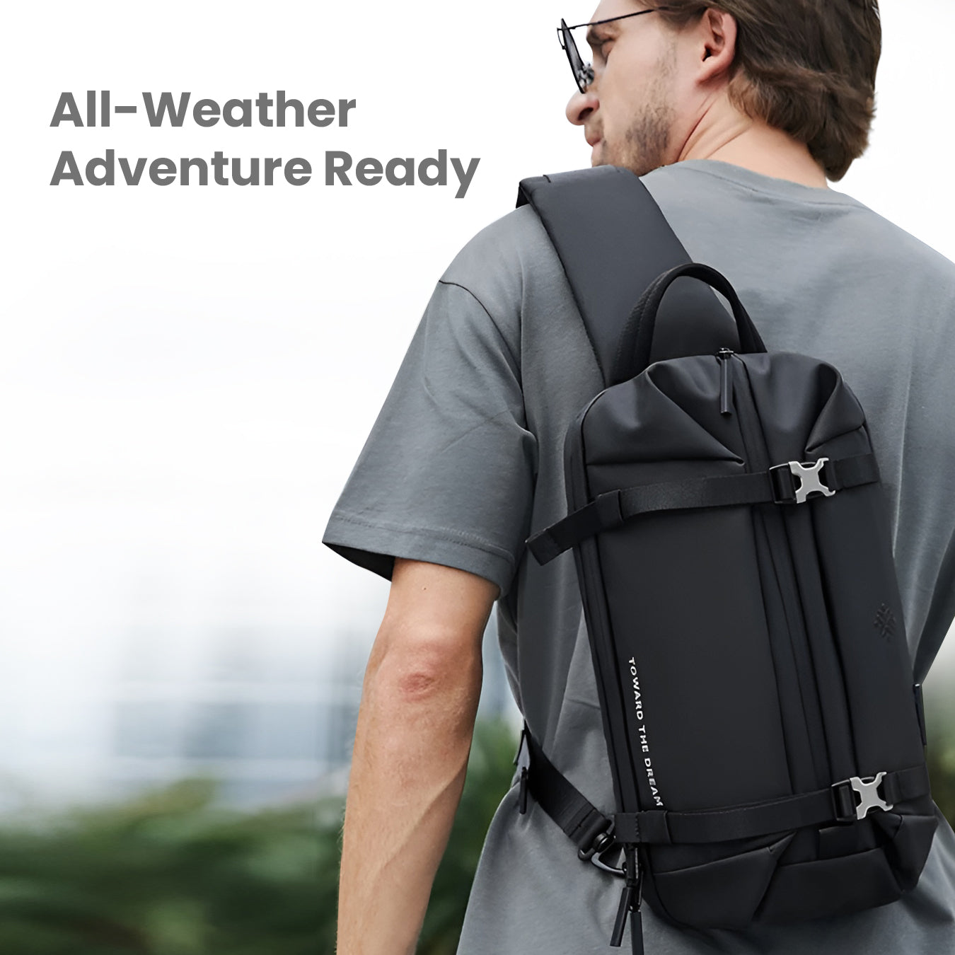 Man wearing black expandable anti-theft chest bag, ideal for travel and outdoor adventures. Features secure straps and sleek design.