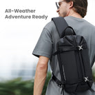 Man wearing black expandable anti-theft chest bag, ideal for travel and outdoor adventures. Features secure straps and sleek design.