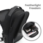 Black ProtecX charging chest bag with multiple compartments, showcasing tech gadgets like a smartphone and camera lens. Lightweight, versatile design.