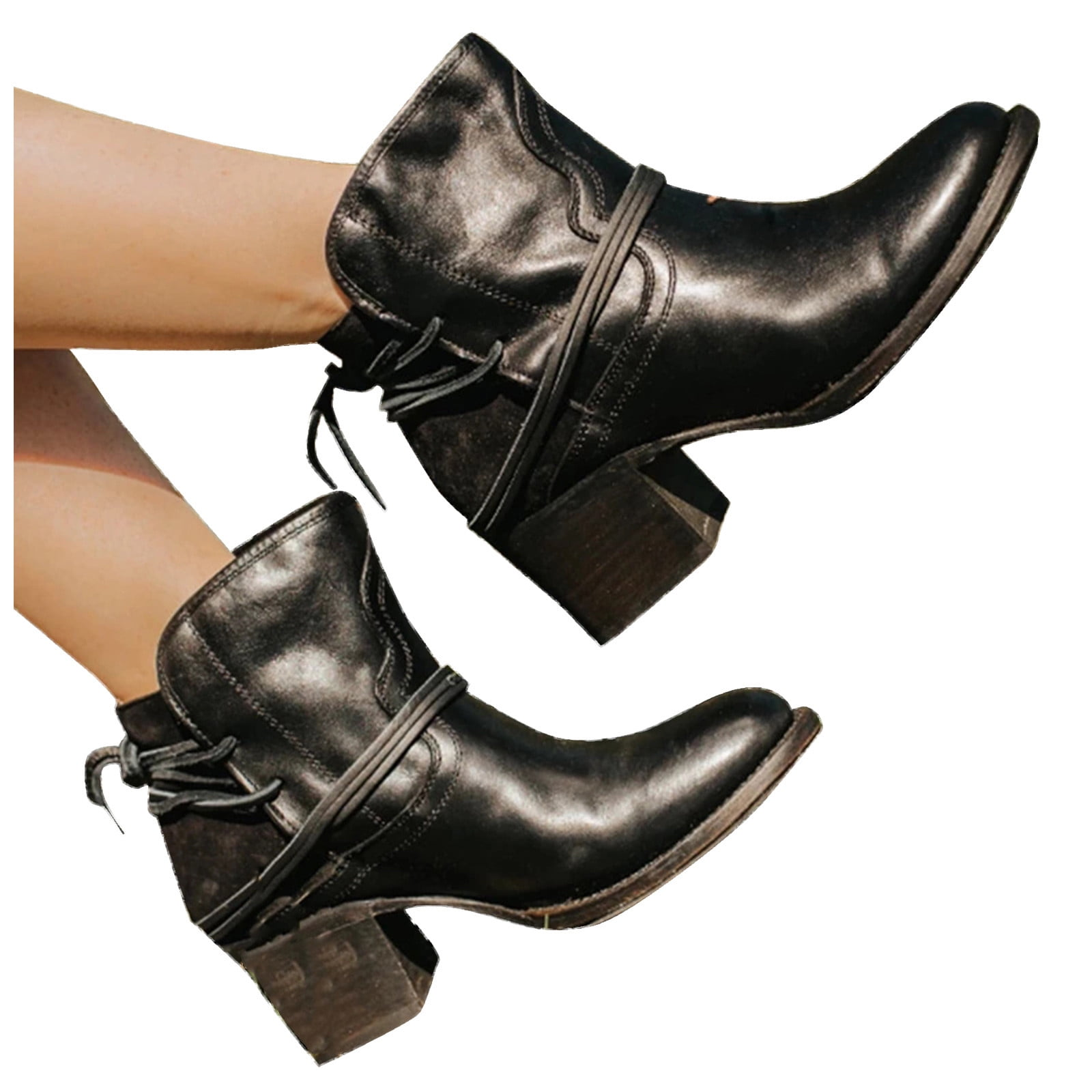 Black leather ankle boots with chunky heels and decorative straps, perfect for women's fashion. Stylish footwear for casual and formal outfits.