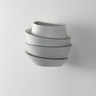 Modern white wall-mounted planter with a sleek, layered design, perfect for indoor vertical gardening and home decor. Minimalist plant holder.