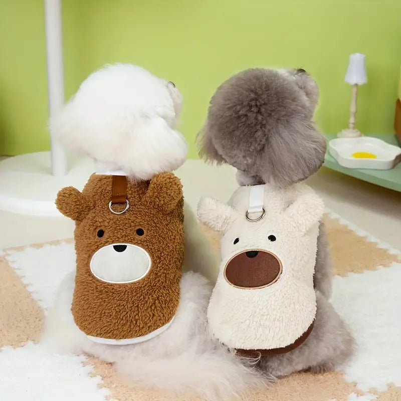 Cute dogs wearing bear-themed fleece jackets, sitting on a cozy rug in a playful room. Pet fashion, dog clothing, adorable pet outfits.