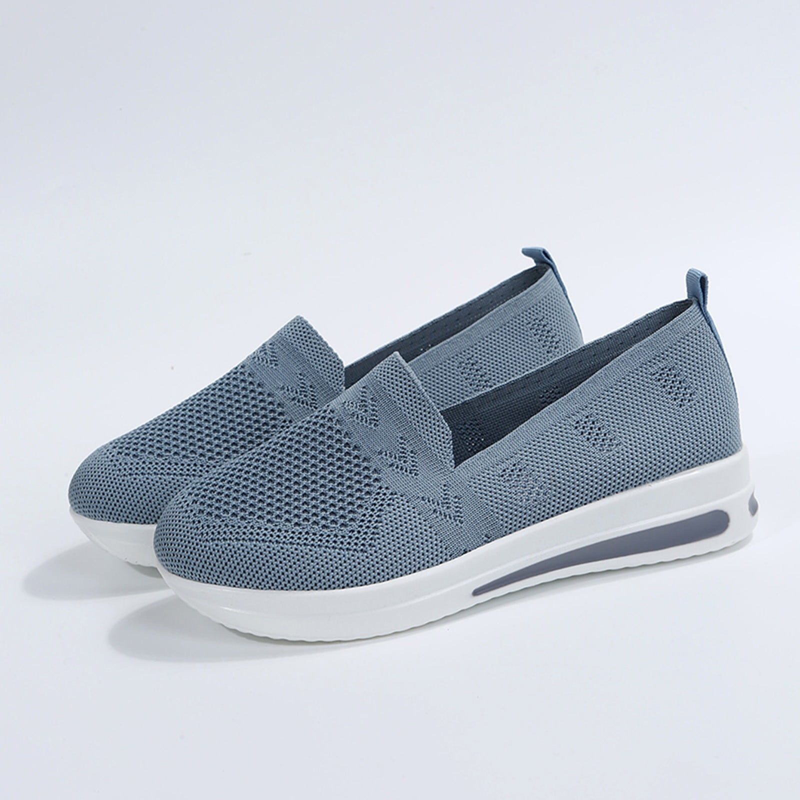 Blue slip-on sneakers with breathable mesh upper and cushioned white sole, ideal for casual wear. Lightweight, comfortable women's footwear.