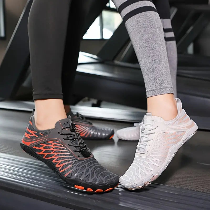 Two people wearing minimalist barefoot running shoes on a treadmill, featuring black and orange, and white designs. Fitness footwear, gym workout.