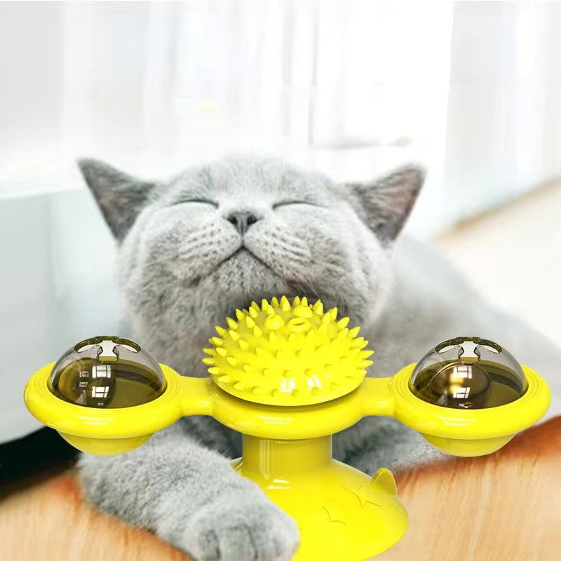 Gray cat enjoying a yellow interactive cat toy with spiky center and rotating balls, perfect for pet entertainment and enrichment.