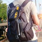 Person with a polka dot backpack holding a map at a train station platform, travel and adventure concept, outdoor exploration, summer journey.