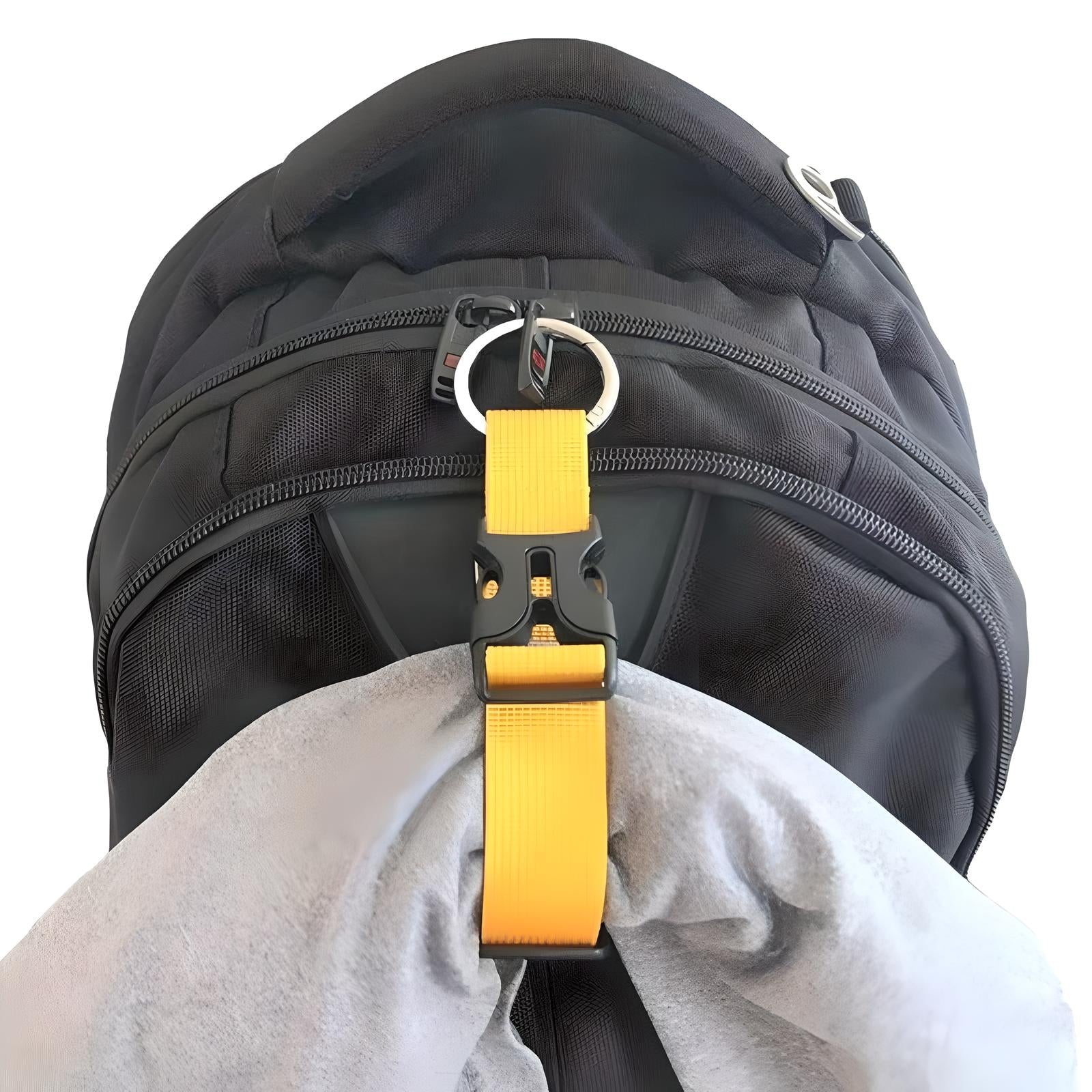 Black backpack with multiple zippers, featuring a yellow strap and buckle attachment holding a gray fabric. Ideal for travel and outdoor activities.