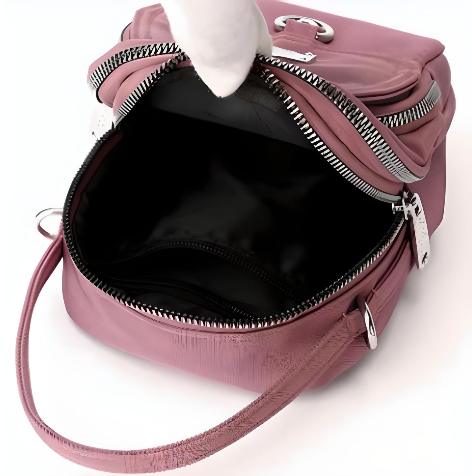 Pink leather handbag with silver zippers, open to reveal spacious black interior; stylish women's accessory, perfect for fashion and travel.