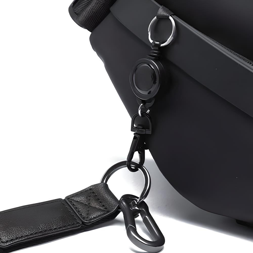 Close-up of a black leather bag with a detachable strap and metal carabiner clip, showcasing durable hardware and sleek design. Perfect for travel or daily use.