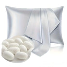 Luxurious white silk pillowcase with smooth texture, accompanied by silk cocoons. Perfect for hair and skin care, hypoallergenic bedding accessory.