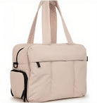 Beige travel duffel bag with multiple pockets, durable straps, and sleek design. Ideal for gym, weekend trips, and carry-on luggage.