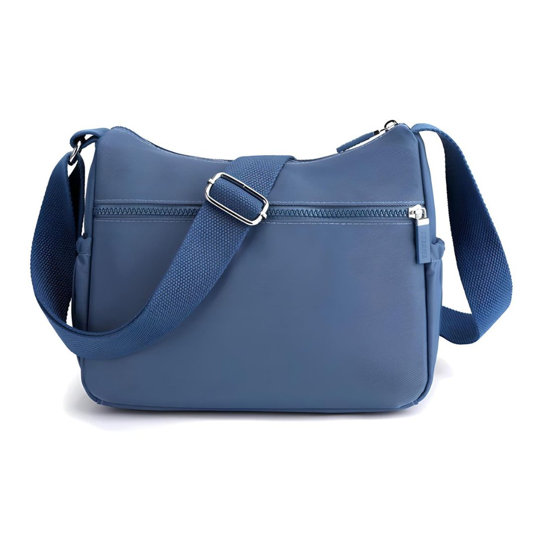 Stylish blue crossbody bag with adjustable strap, front zipper pocket, and sleek design. Perfect for travel, casual outings, and everyday use.