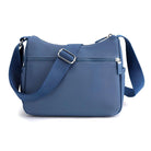 Stylish blue crossbody bag with adjustable strap, front zipper pocket, and sleek design. Perfect for travel, casual outings, and everyday use.