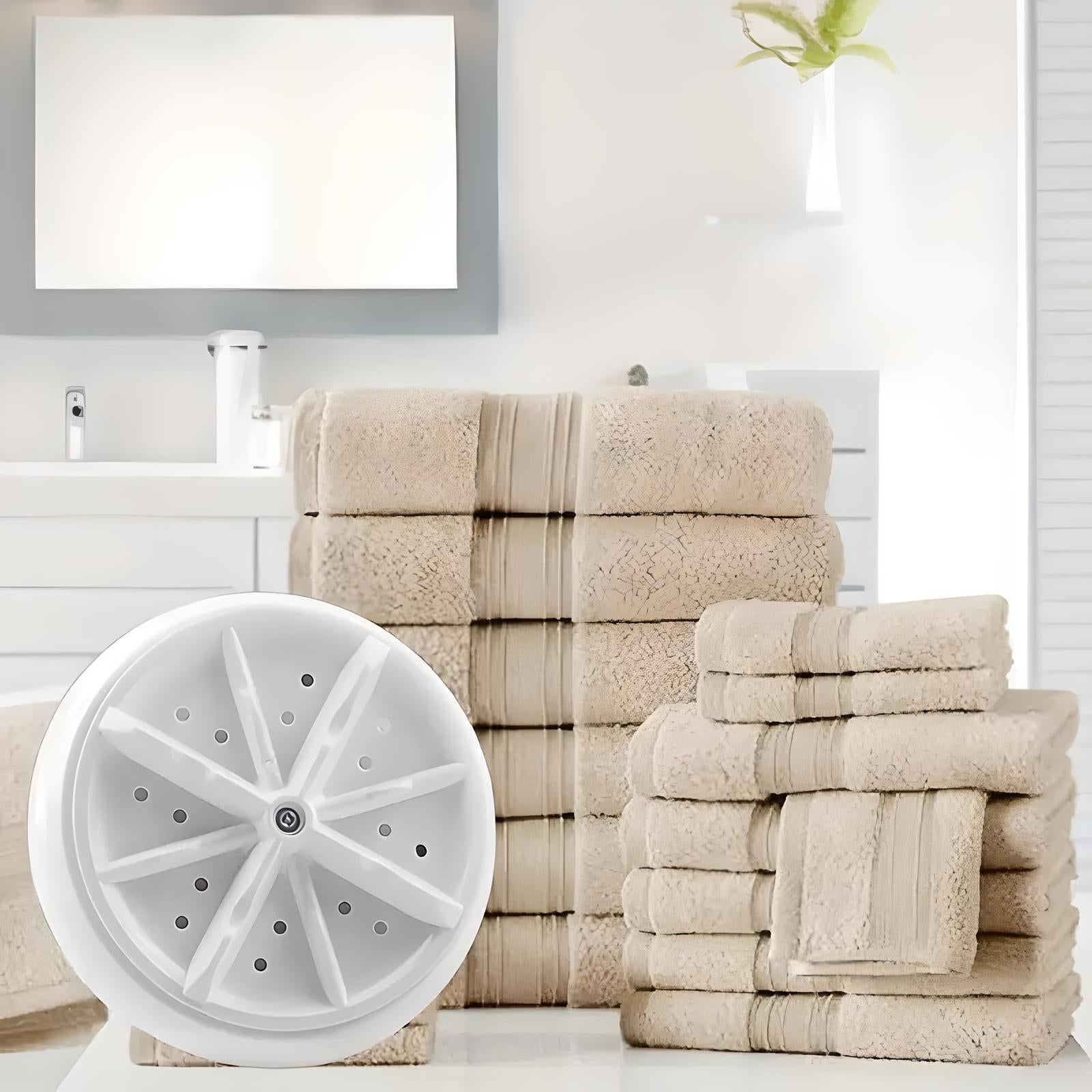 Beige luxury bath towel set stacked in modern bathroom with round white showerhead, elegant decor, soft absorbent cotton, spa-like ambiance.