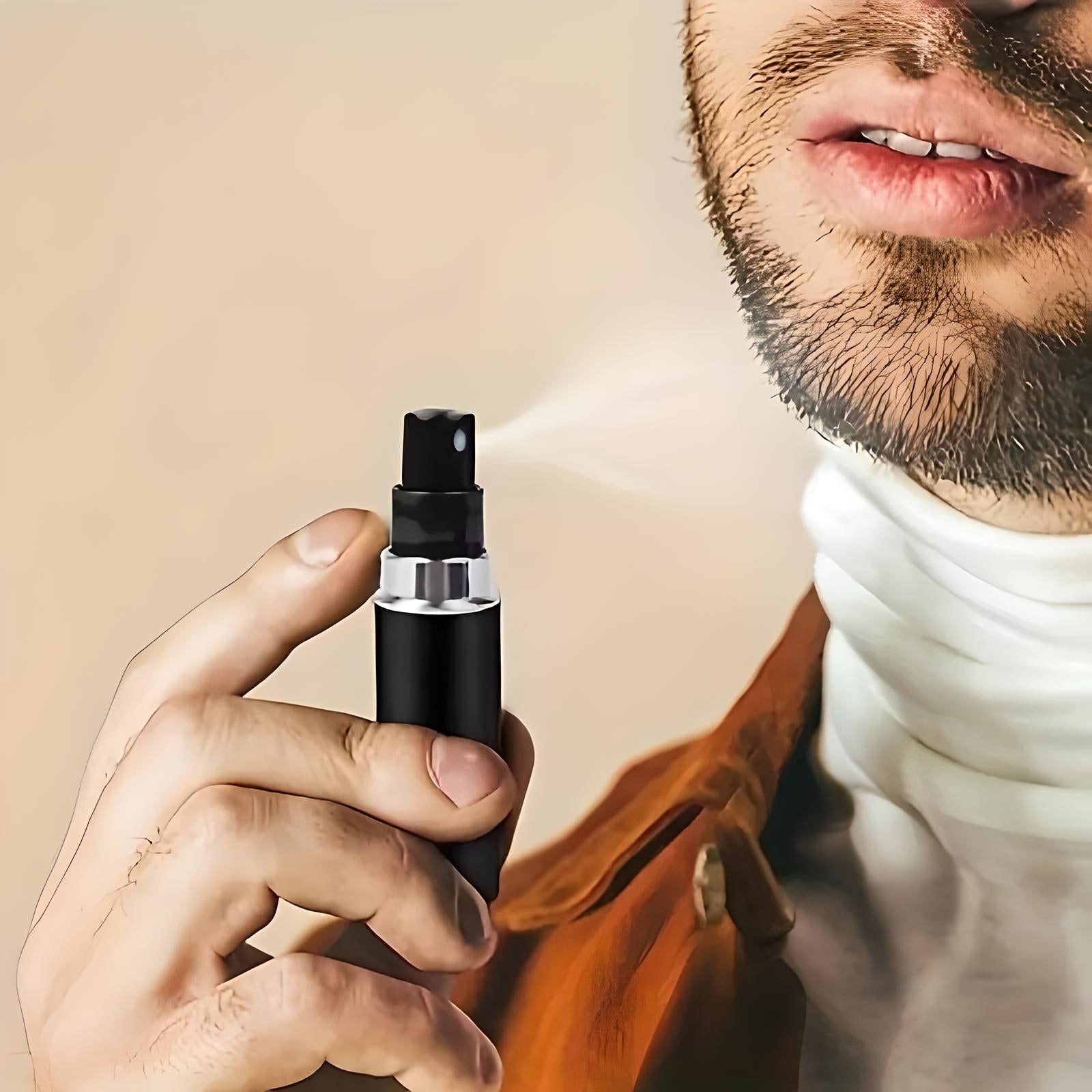 Man using portable black spray bottle for fragrance application; close-up of hand and face. Ideal for travel, personal care, grooming essentials.