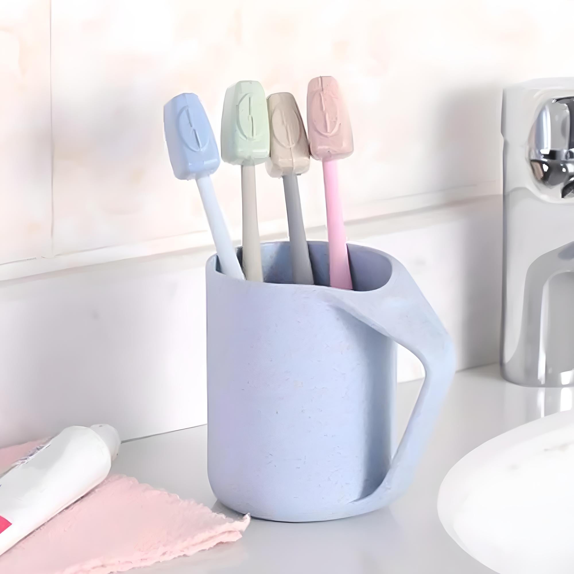 Pastel toothbrushes in a light blue holder on a bathroom counter, next to a faucet and toothpaste. Modern bathroom accessories, dental hygiene essentials.