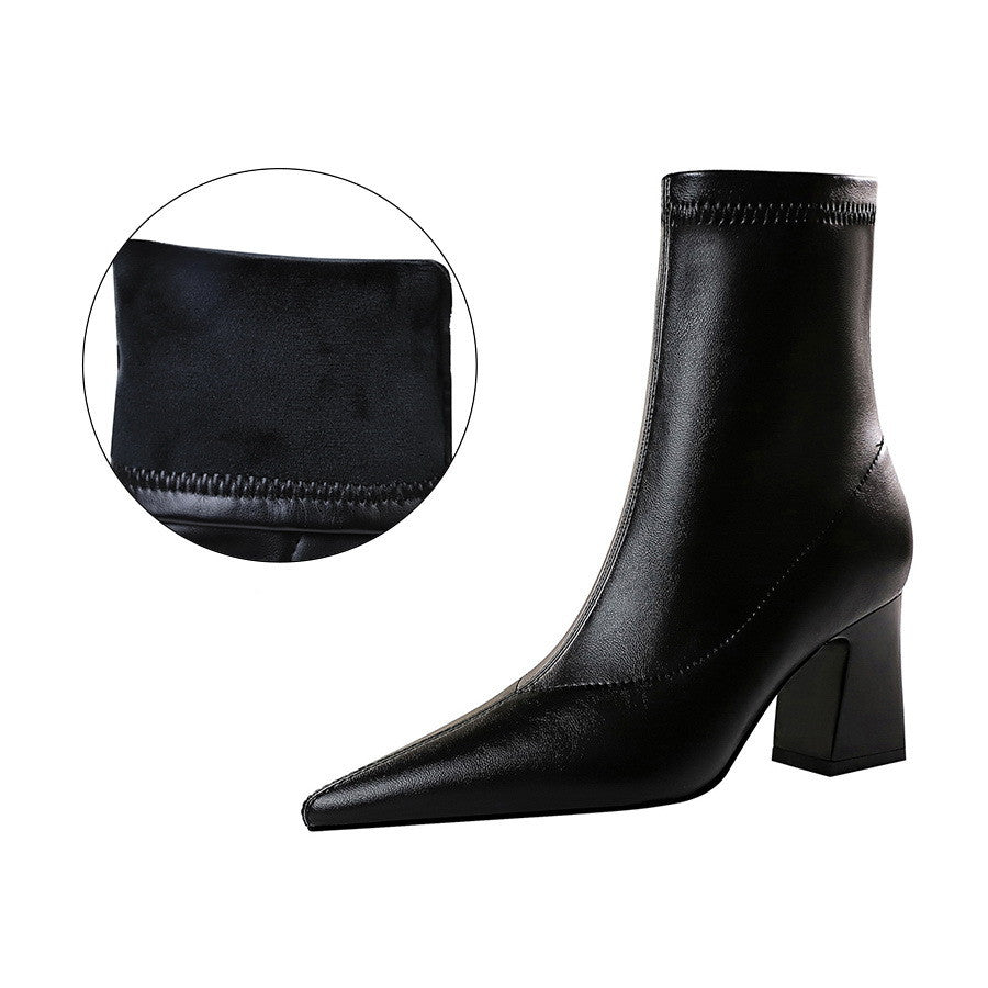 Black leather ankle boot with pointed toe and block heel, featuring detailed stitching. Women's fashion footwear, stylish and elegant design.