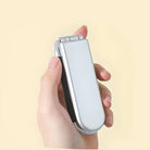 Hand holding a sleek silver portable mini bag sealer, ideal for kitchen storage solutions, food preservation, and snack freshness. Compact and efficient design.