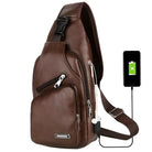 Brown leather sling bag with USB charging port, multiple zippered compartments, and adjustable strap. Ideal for travel, casual use, and tech-savvy users.