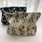 Floral fabric storage bags with daisy patterns, featuring a beige and black design, perfect for home organization and decor. Sozakka brand.