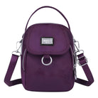 Purple crossbody bag with adjustable strap, front flap, and silver hardware. Stylish women's handbag for everyday use. Fashion accessory.