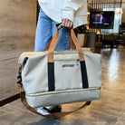 Person holding a beige Beichao travel duffel bag with brown handles and black straps, ideal for stylish travel and luggage solutions.