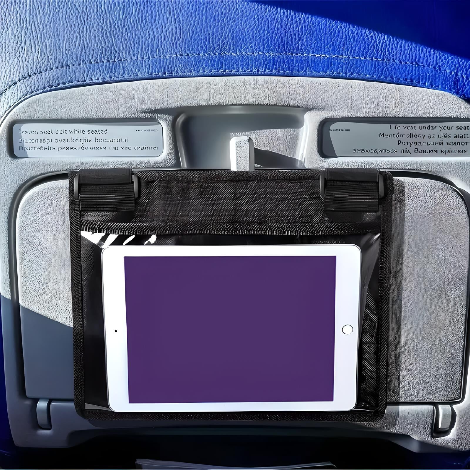 Airplane seat back with tablet holder displaying a blank screen, attached to tray table. Ideal for in-flight entertainment and travel convenience.