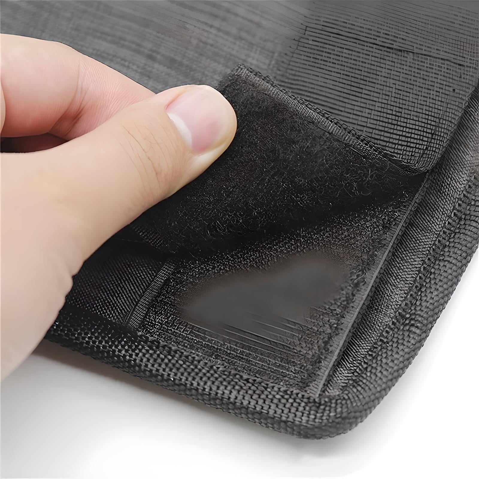 Close-up of a hand peeling back a black Velcro strap on a durable, textured fabric surface, showcasing secure fastening and high-quality material.