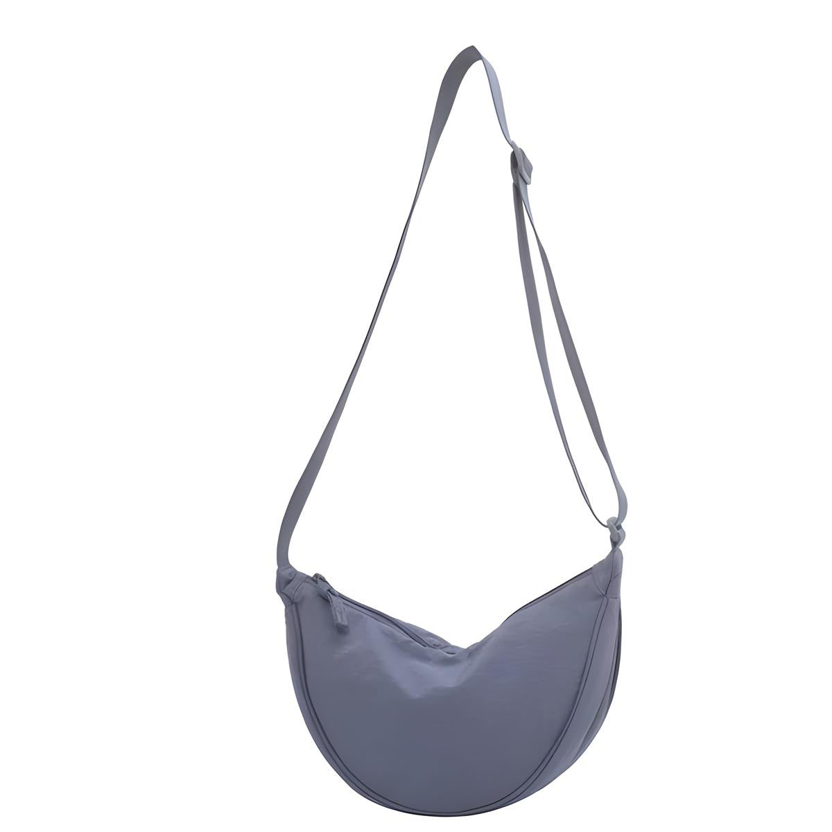 Light blue crossbody bag with adjustable strap, minimalist design, and crescent shape. Perfect for casual outings and everyday use. Fashion accessory.