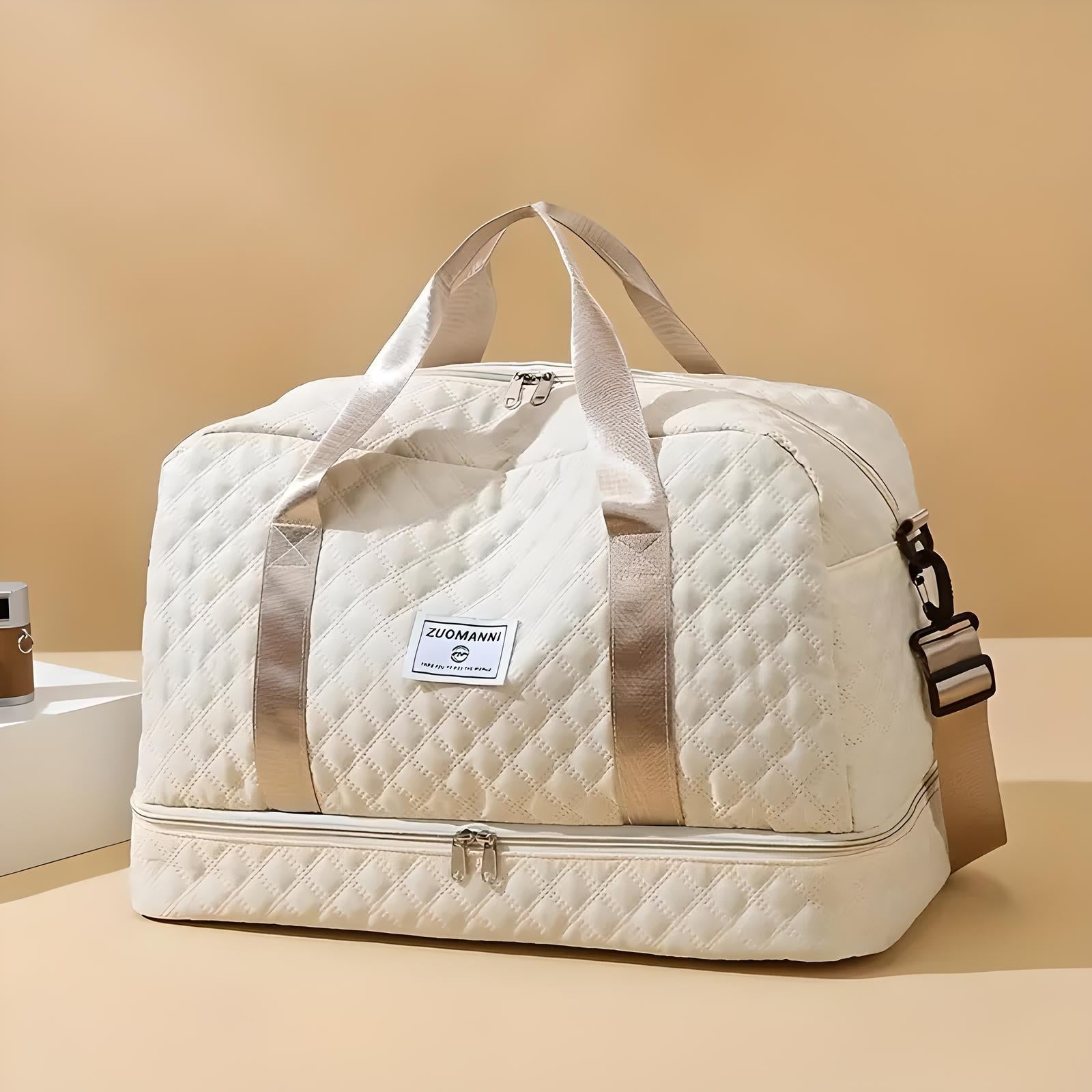 Quilted beige travel duffel bag with dual handles and adjustable shoulder strap, featuring a spacious design and front logo patch, ideal for weekend trips.