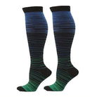 Knee-high compression socks with gradient blue to green stripes, designed for improved circulation and comfort. Ideal for travel, sports, and daily wear.