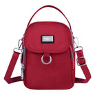 Red crossbody bag with adjustable strap, front flap, and silver hardware. Stylish women's handbag for casual outings. Fashion accessory.