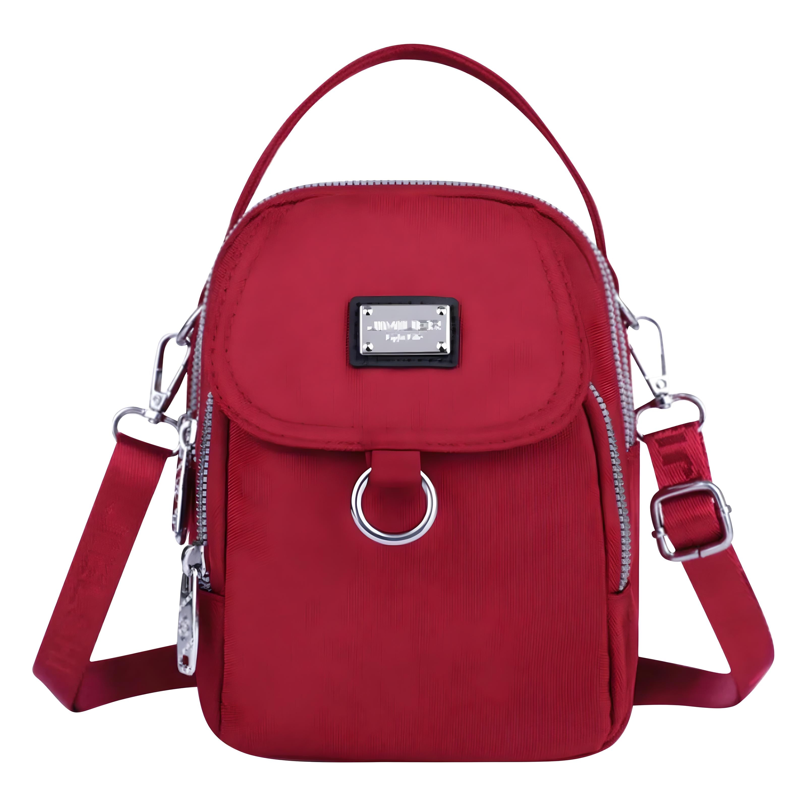 Red crossbody bag with adjustable strap, front zipper pocket, and metal ring detail. Stylish women's handbag, perfect for casual or travel use.