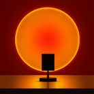 Modern sunset projection lamp casting warm orange glow on wall, creating ambient lighting. Perfect for home decor, mood lighting, and relaxation.