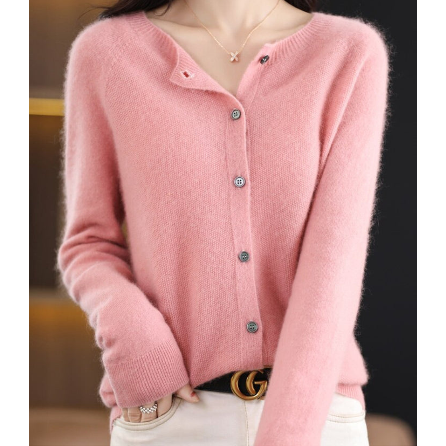 Pink cashmere cardigan sweater with button-up front, worn by a model, stylish women's fashion.
