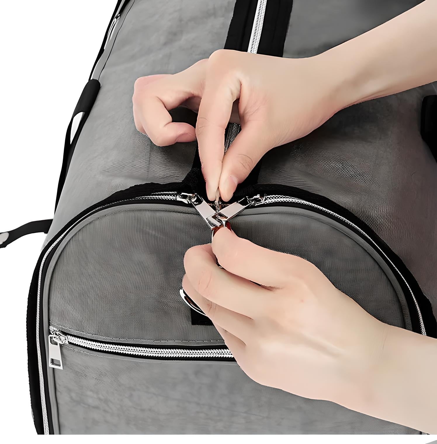 Hands zipping a gray travel duffel bag with black accents, showcasing durable zippers and spacious design. Ideal for travel, gym, or weekend trips.