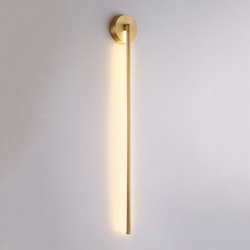 Modern gold wall sconce with vertical LED light, minimalist design, ideal for contemporary home decor and ambient lighting solutions.