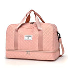 Quilted pink travel duffel bag with dual handles, detachable shoulder strap, and front logo patch. Ideal for weekend trips and gym use.