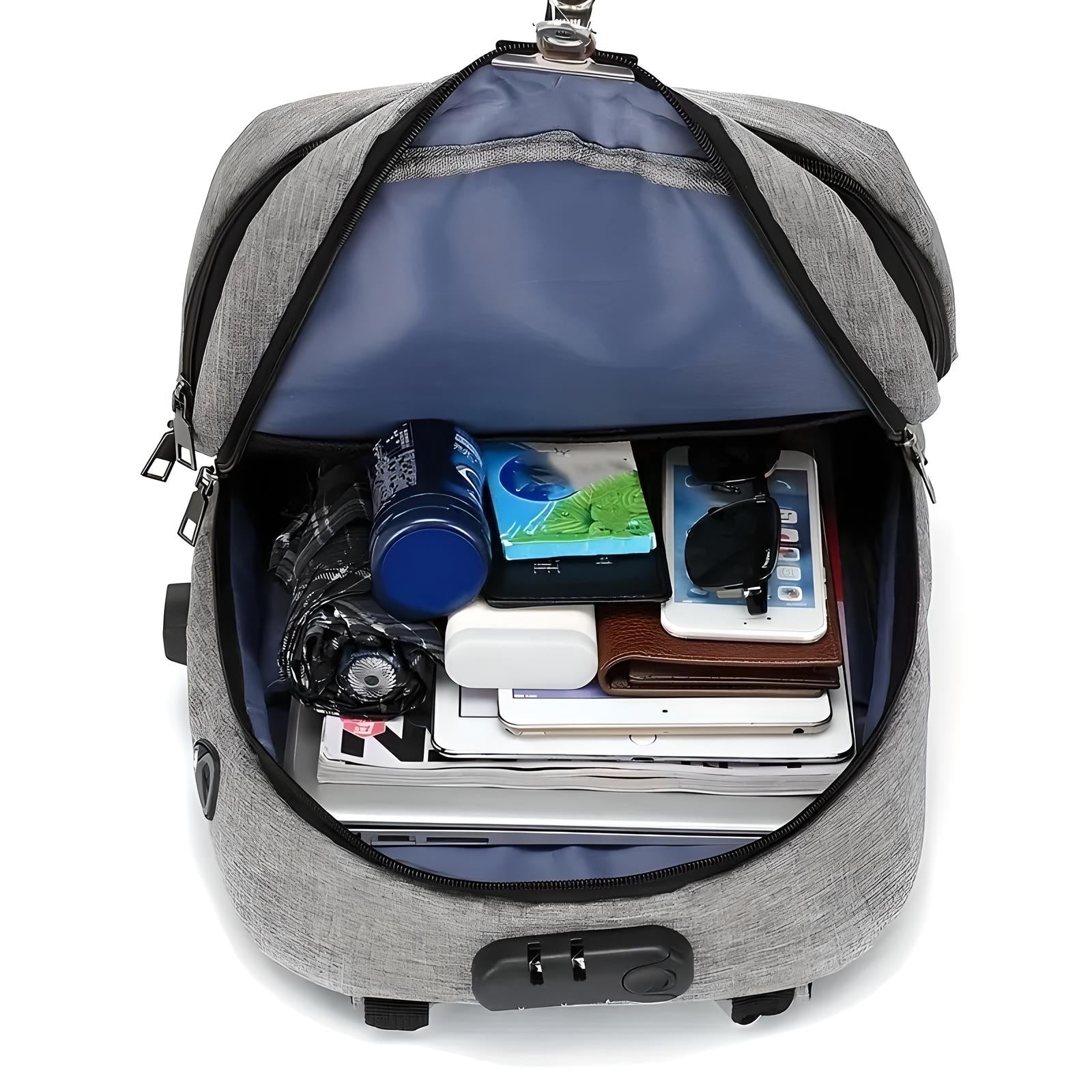 Open gray anti-theft backpack with multiple compartments, showcasing organized storage of gadgets, books, and personal items. Ideal for travel and daily use.