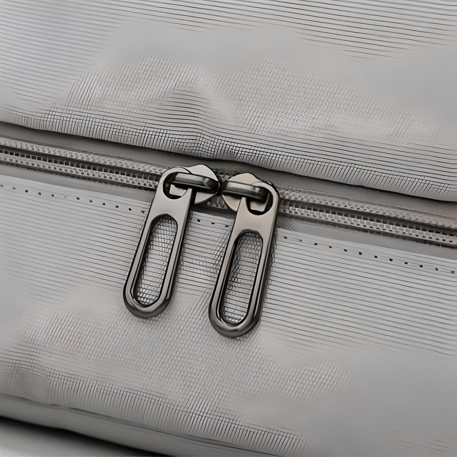 Close-up of a gray suitcase zipper with dual metal sliders, showcasing durable luggage design. Ideal for travel, secure storage, and easy access.