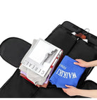 Person packing clothes and magazines into a black garment bag, featuring a blue "WALKIN" shirt and "CEREAL" magazine. Travel essentials organization.