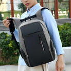 Man holding a sleek, modern anti-theft backpack with USB charging port, ideal for travel and daily use. Stylish, durable design in urban setting.