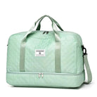 Mint green quilted travel duffel bag with dual handles, adjustable shoulder strap, and spacious compartments. Ideal for weekend trips and gym use.