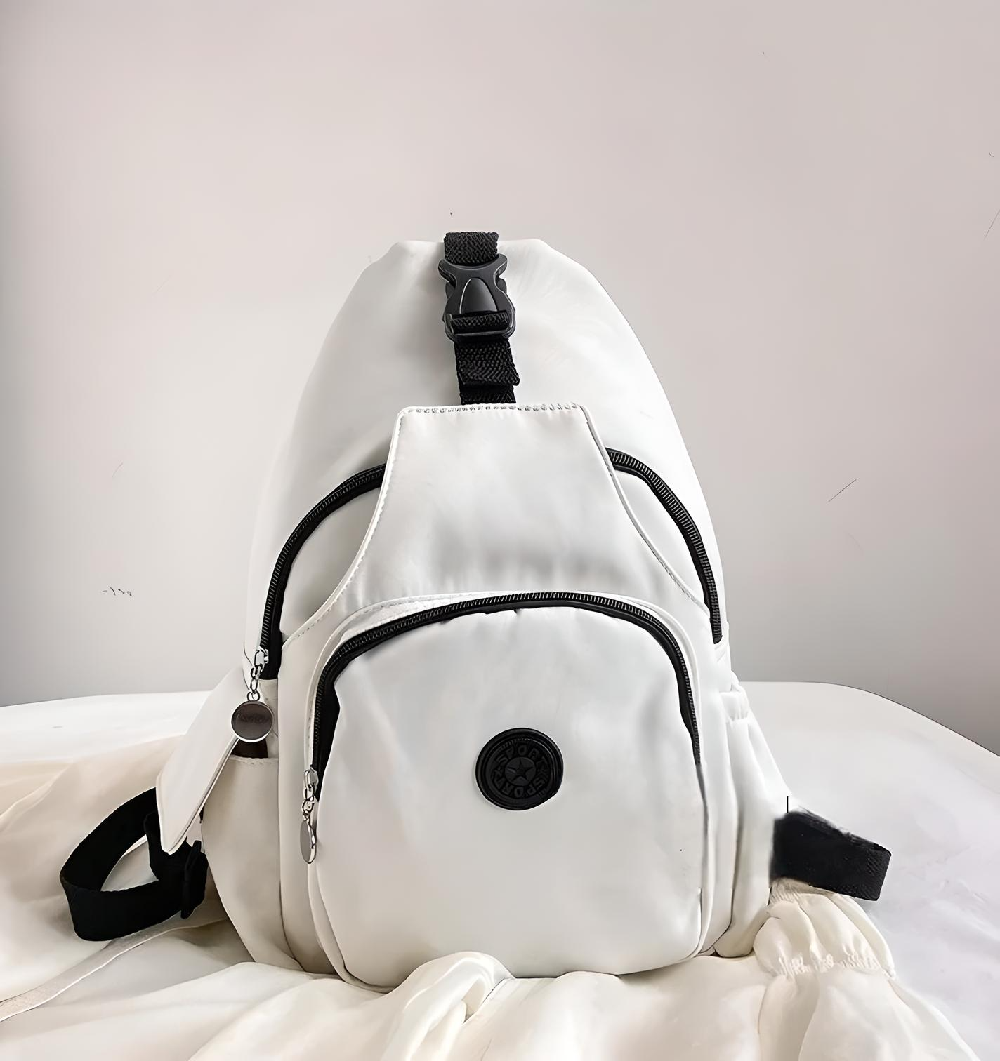 White backpack with black zippers and adjustable straps, featuring a front pocket and circular logo. Ideal for travel, school, or casual use.