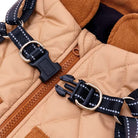 Close-up of a tan quilted backpack with black adjustable straps and metal buckles, highlighting durable zippers and stylish design.