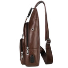 Brown leather crossbody bag with adjustable strap, side view. Features multiple zippered compartments and sleek design. Perfect for travel or daily use.