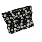 Floral cosmetic bag with white daisy pattern on black background, featuring a zipper closure. Perfect for travel or everyday use. Stylish and practical.