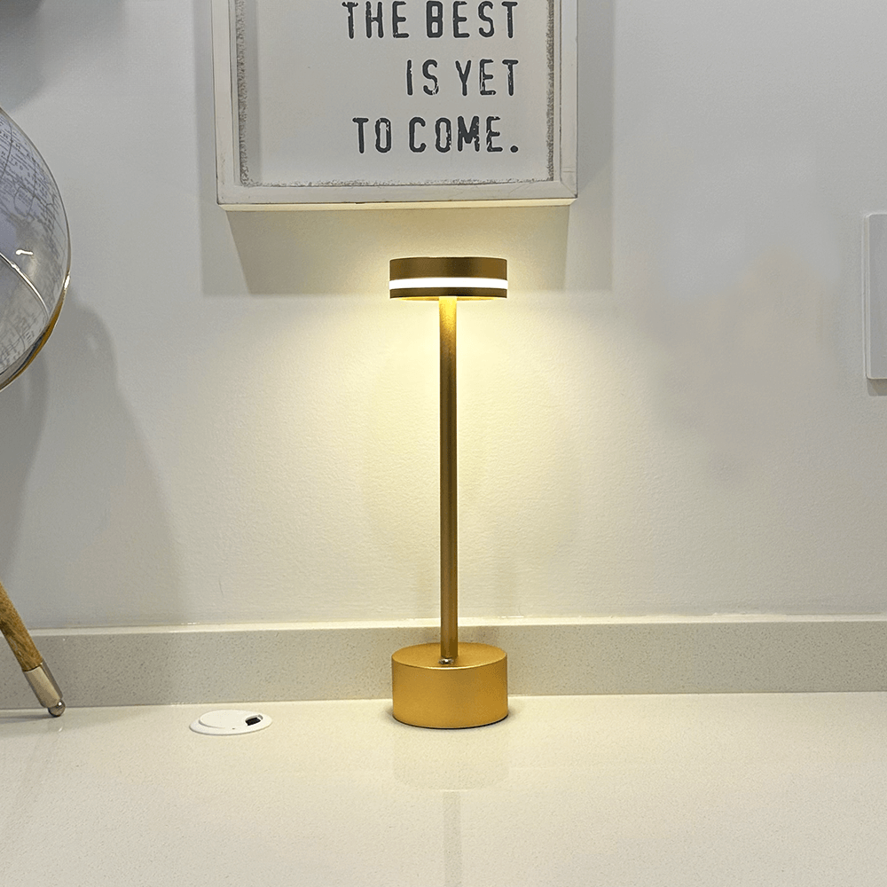 Modern gold table lamp with sleek design, illuminating a minimalist room. Perfect for contemporary home decor and ambient lighting solutions.